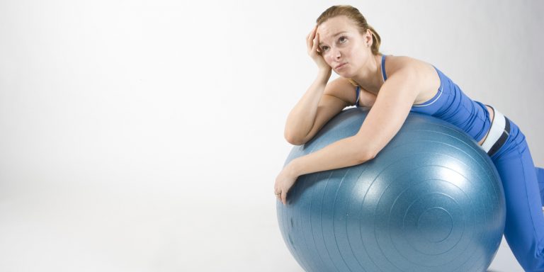 Frustrated woman on exercise ball